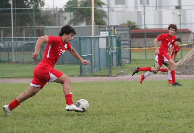 Senior Dante Mailhofer drives the ball down the field as his teammate Nicolas Miller is ready for the pass. Facing Hialeah Gardens, the Gables soccer team worked hard for a taste of victory.