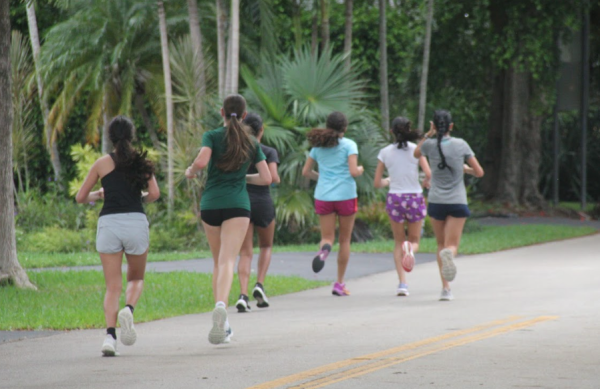 On their run to UM, the girls cross country team practice running a routine route with a different pace in mind each time. 