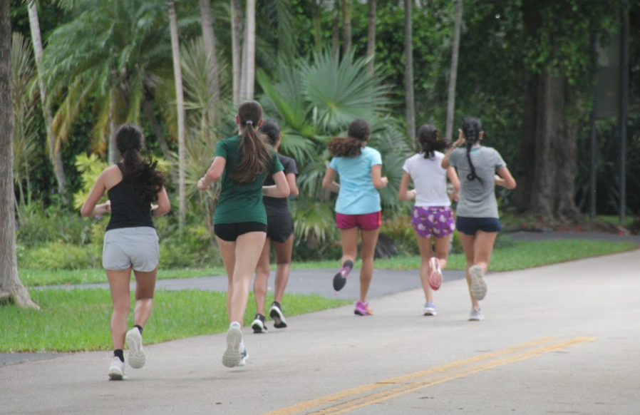 On their run to UM, the girls cross country team practice running a routine route with a different pace in mind each time. 