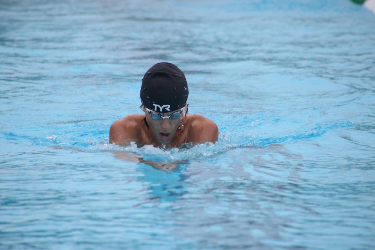 The swimmer pierces the water to gain speed and beat his opponents.  