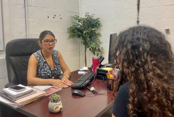 Ms. Ramirez consoles one of her visitors about how a positive mindset is healthy for the body.