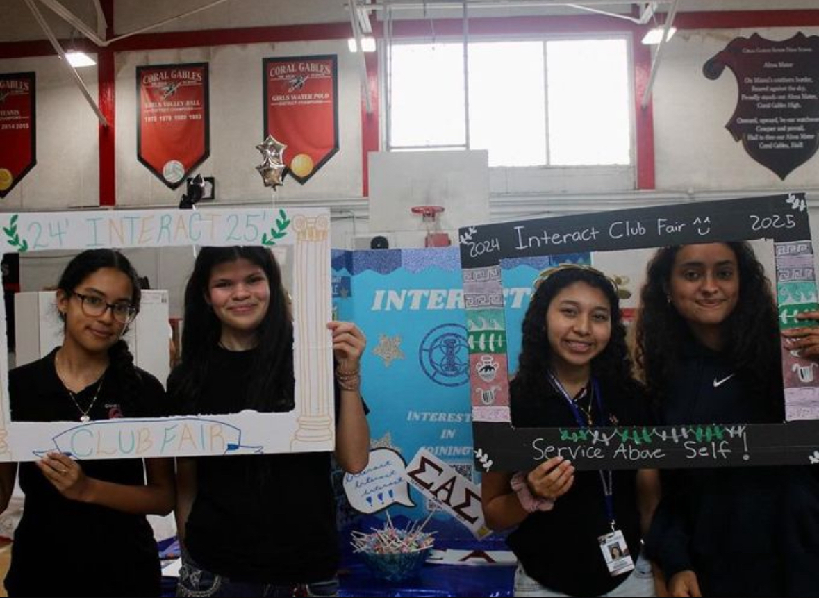 Posing with cardboard cutouts, members on the board of the Interact club allow others to pose with the very same cutouts after joining the club. 