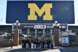 Juniors from the Class of 2026 jump in front of the University of Michigan stadium, commemorating the end of an unforgettable trip. 