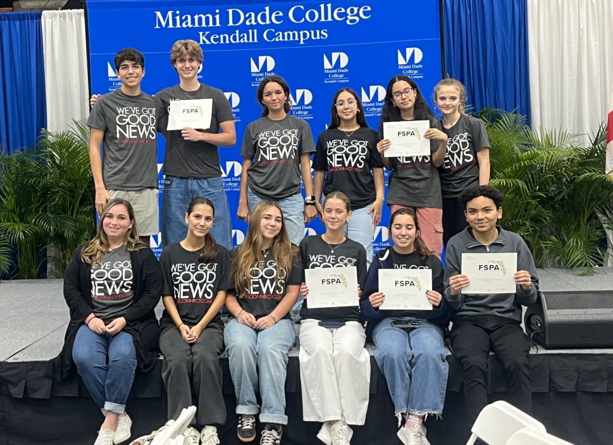 CavsConnect staff members take a group photo after receiving their award,, holding a total of 6 awards from their submissions.