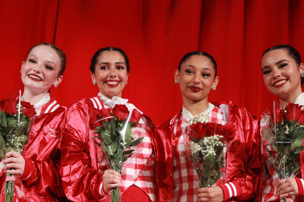 The Senior Gablettes smile after receiving their senior jackets and rose bouquets from their male Sweethearts.