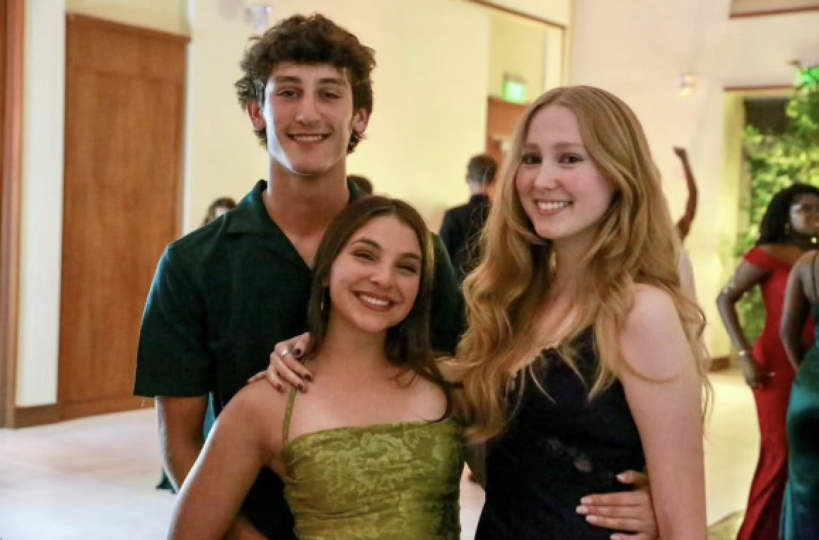 Seniors Caitlin Savage (right), Melissa Hernandez (center) and Evan Noval (left)pose in the entrance of the center, awaiting a night of surprises, included that which announce the last two as winners of Homecoming Court. 