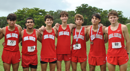 The varsity boys team was eager to pose after their race upon finding out they were going to the states championship race.