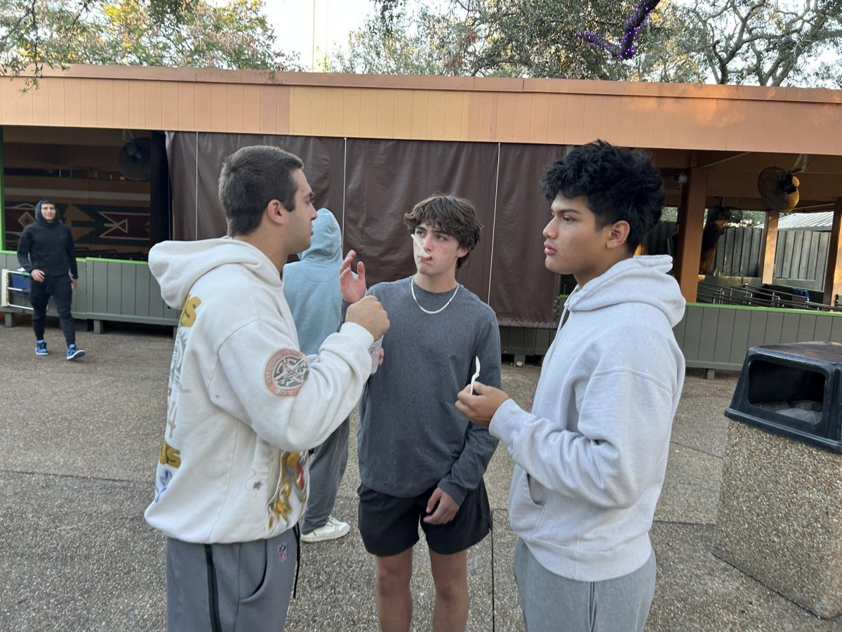 Students Cooper Piedra, Andres Amador, and Santiago Paez discuss which attraction they should go on next.