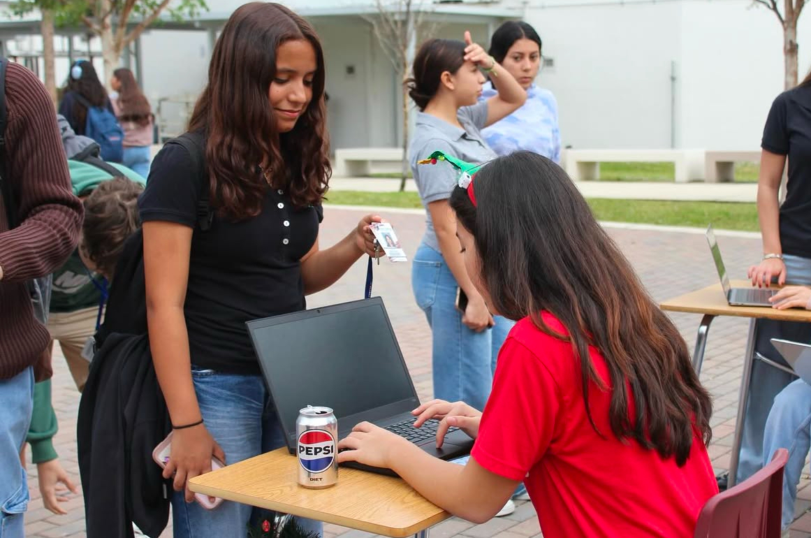 Sophomores sign in at the 6000 courtyard, verifying their eligibility to join the holiday treat day celebration filled with cookies and cheer.