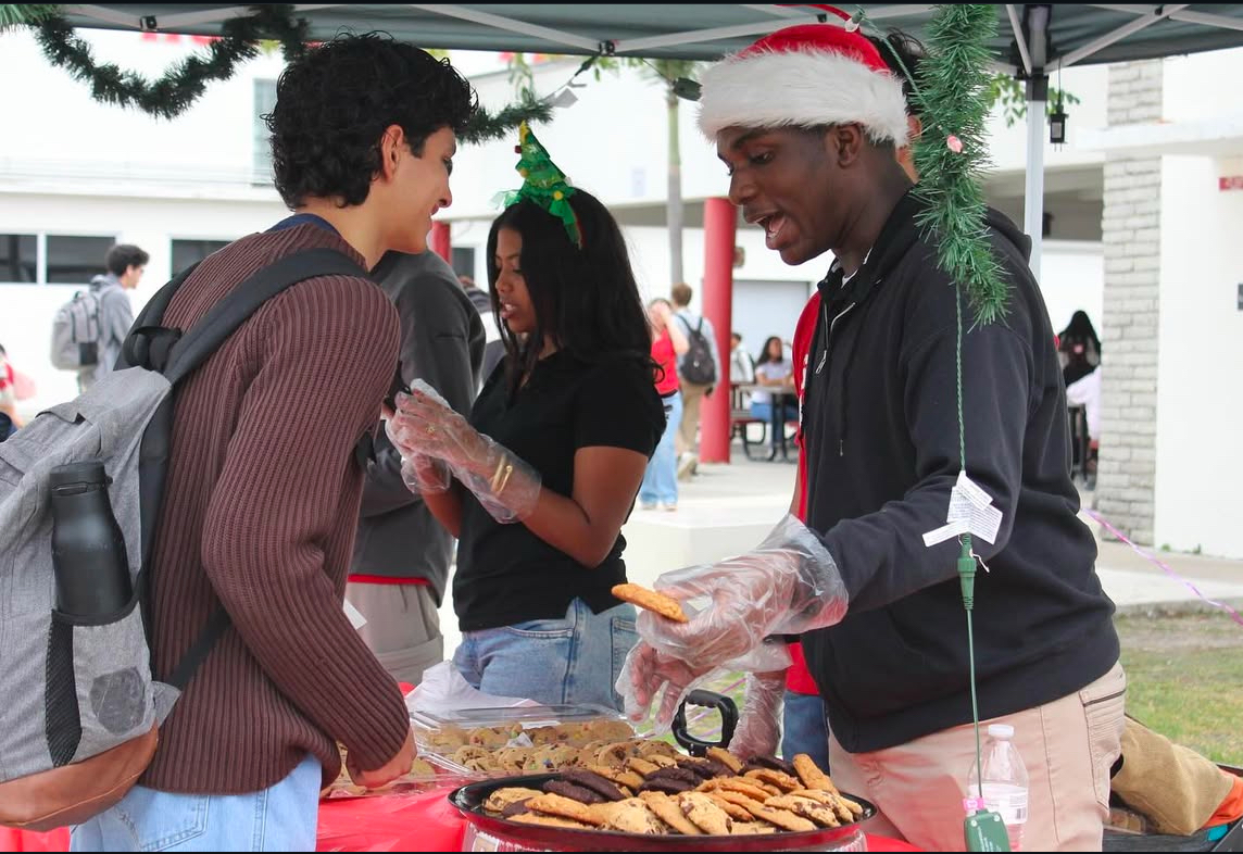 Sophomore board members distribute cookies to their classmates, ensuring everyone enjoys a sweet moment of holiday cheer.