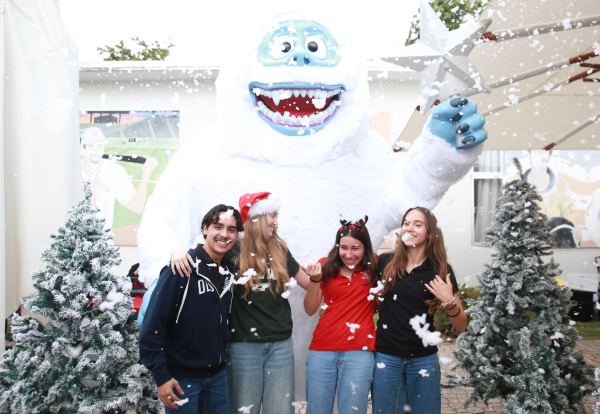 Seniors and volunteering freshman pose in front of the roaring Yetti. Enjoying the winter ambiance, they pose amidst showers of snow bubbles. 