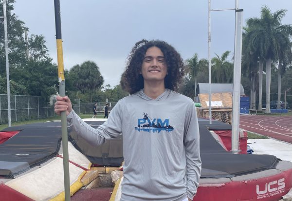 Senior Andrew Barragan prepares for an intense work out for pole vaulting. Holding his pole, he will be warming up for his practice and doing exercises to help him prepare for the 2025 track and field season.